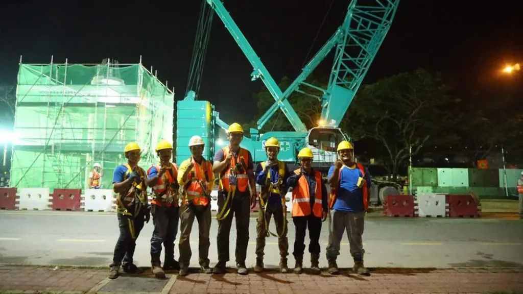 Crawler crane positioning a precast pier cap on the LRT3 line